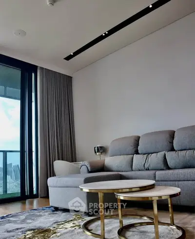 Modern living room with elegant sofa and city view balcony.