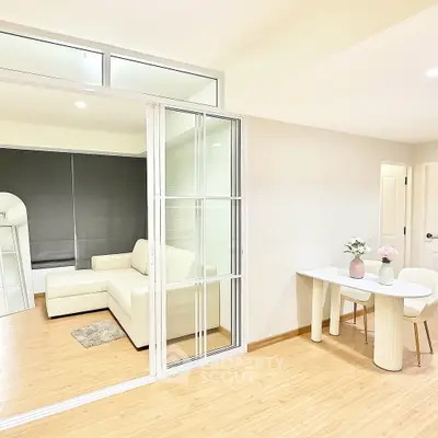 Modern living room with sliding glass doors and cozy dining area