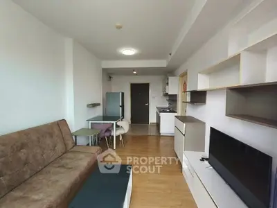 Modern living room with stylish furniture and open kitchen layout in a cozy apartment.