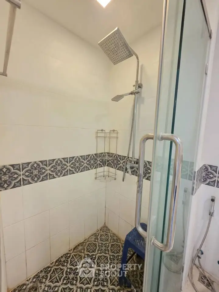 Modern bathroom with stylish shower and decorative tiles