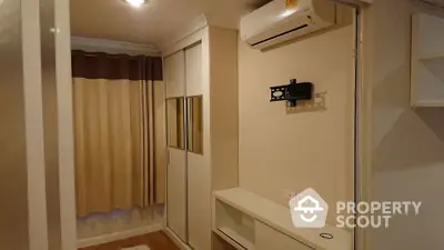 Modern bedroom with built-in wardrobe and air conditioning unit