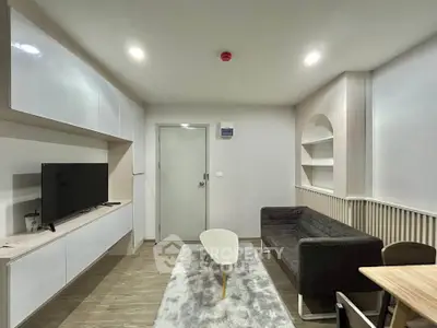 Modern living room with sleek furniture and built-in storage, perfect for urban living.