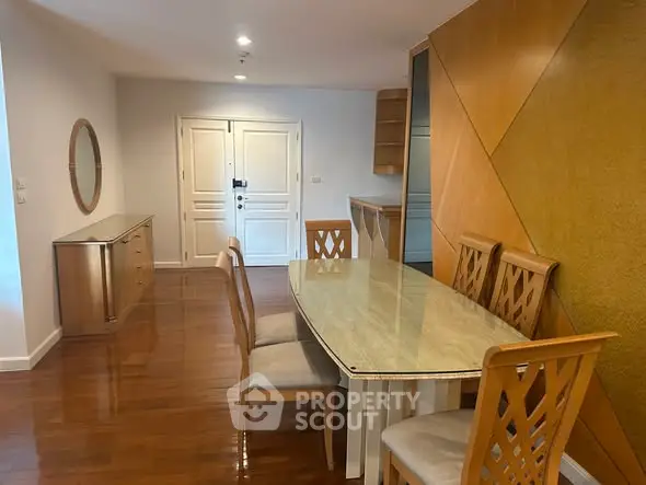 Spacious dining area with elegant wooden furniture and modern decor