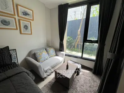 Cozy living room with modern decor and large window overlooking garden