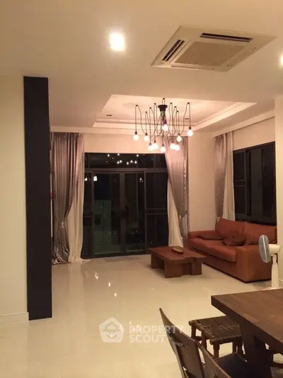 Spacious modern living room with elegant lighting and leather sofa