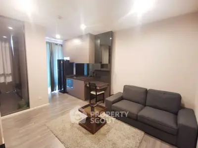 Modern living room with cozy sofa and stylish kitchen in open layout apartment