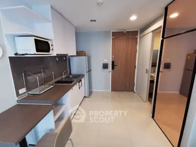 Modern kitchen with sleek appliances and open layout in a stylish apartment.