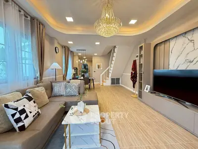 Luxurious living room with elegant chandelier and modern decor