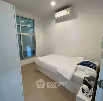 Cozy minimalist bedroom with air conditioning and modern decor