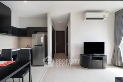 Modern open-plan living room with sleek kitchen and stylish furniture