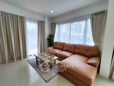 Spacious living room with modern sectional sofa and large windows