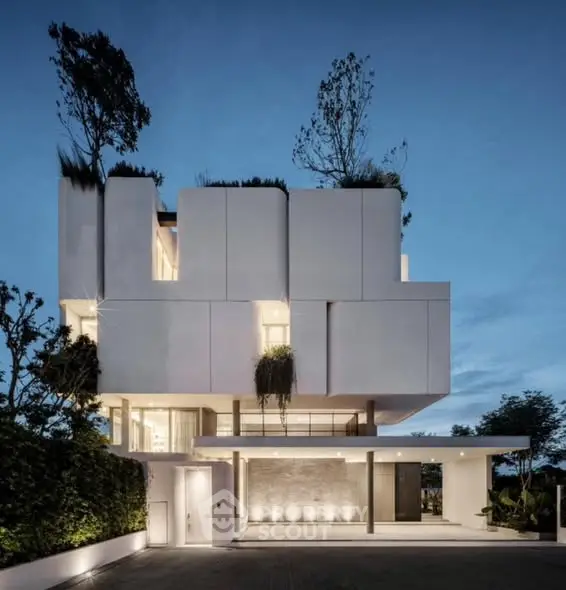 Stunning modern architectural home with unique design and lush greenery.