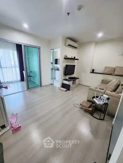 Modern living room with sleek flooring and cozy seating area