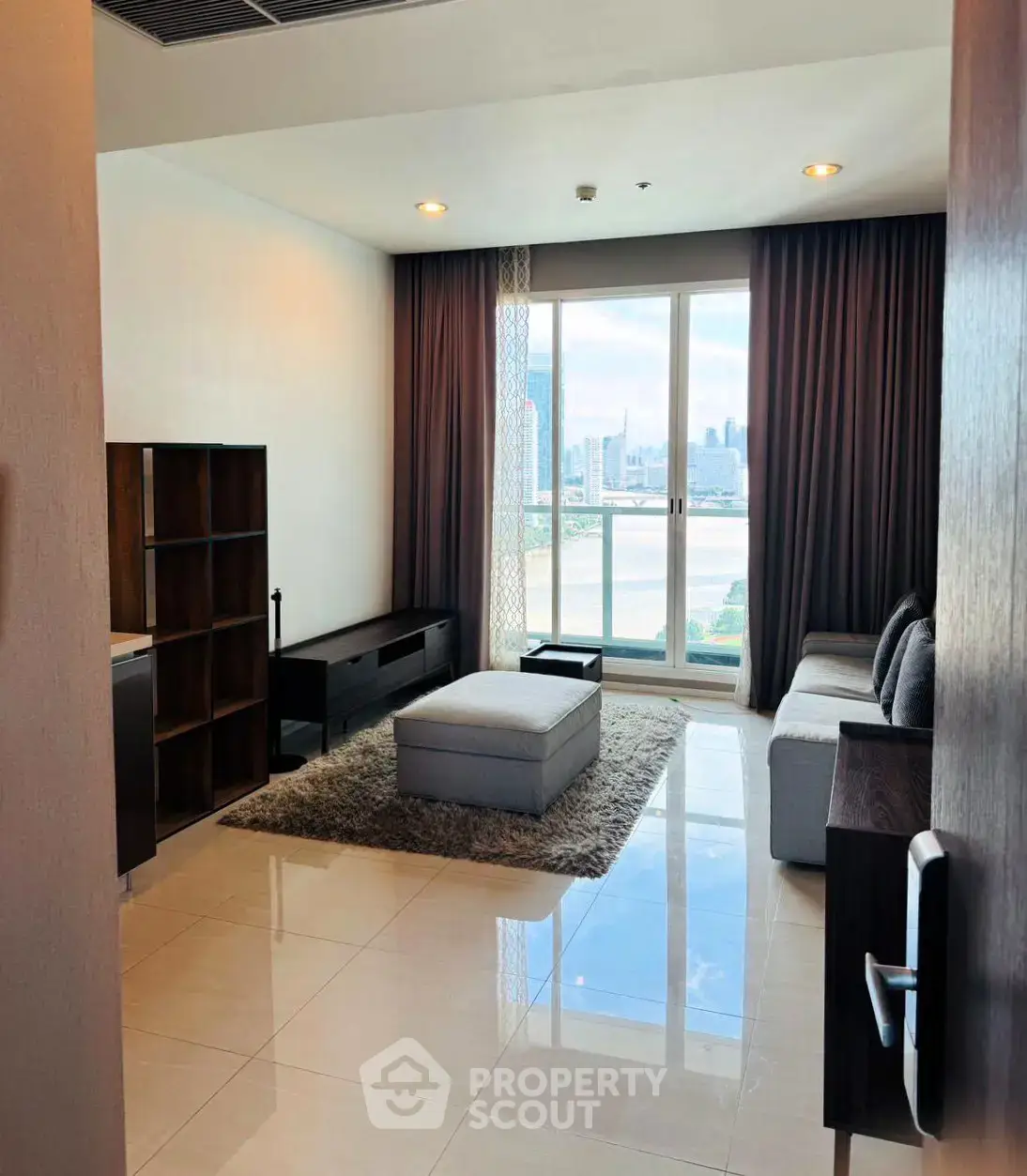 Spacious living room with stunning city view and modern furnishings