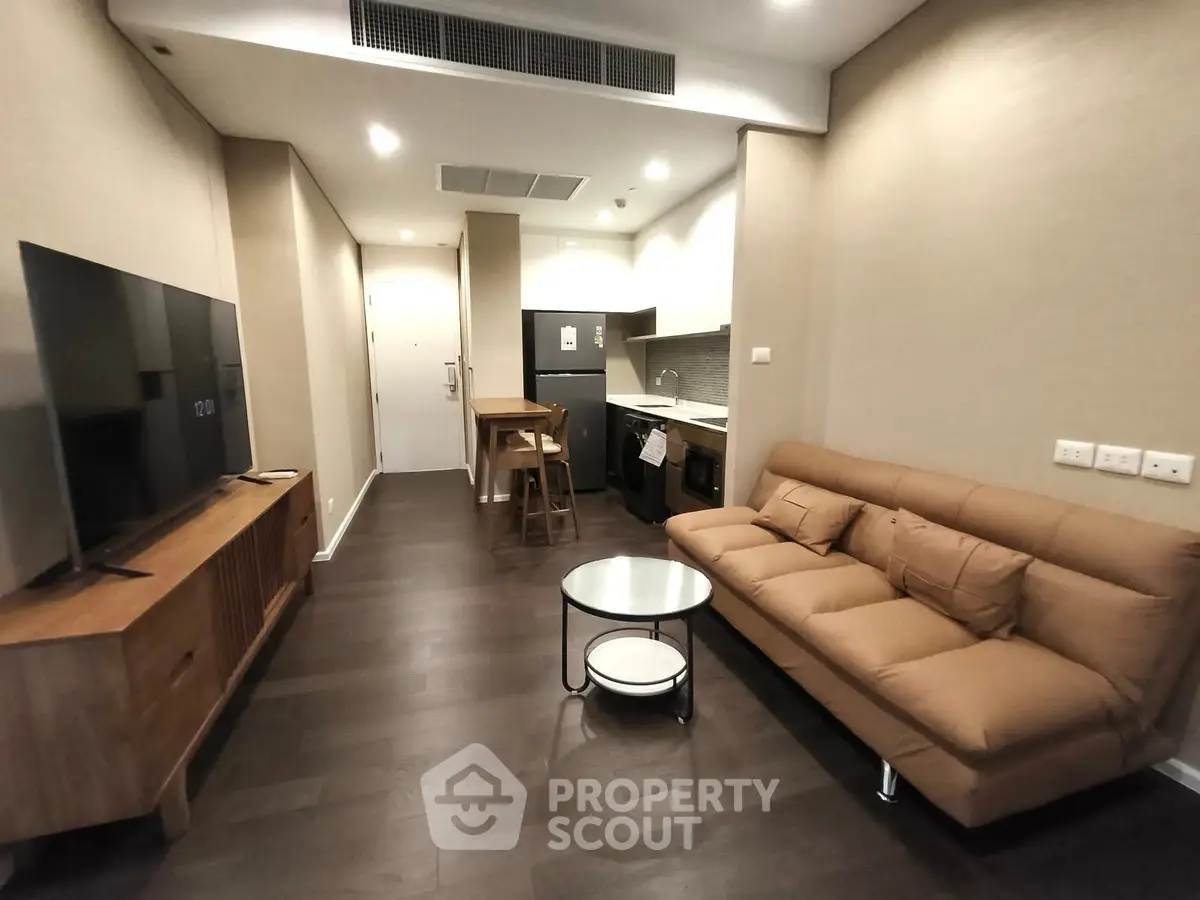 Modern living room with sleek kitchen and cozy sofa in open layout apartment