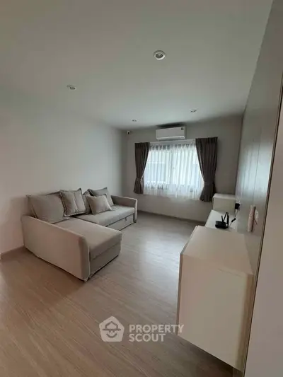 Modern minimalist living room with cozy sofa and natural light