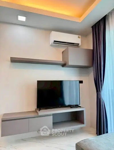 Modern living room with sleek TV setup and ambient lighting