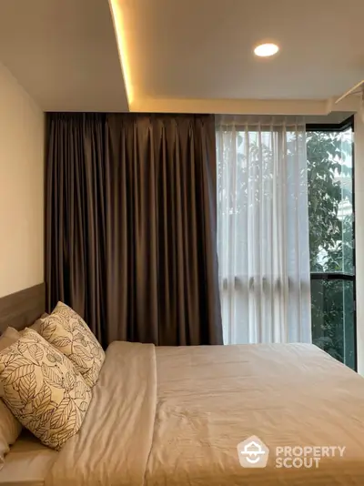 Serene bedroom with ambient lighting, plush bedding, and floor-to-ceiling windows offering a glimpse of nature, perfect for restful nights and tranquil mornings.