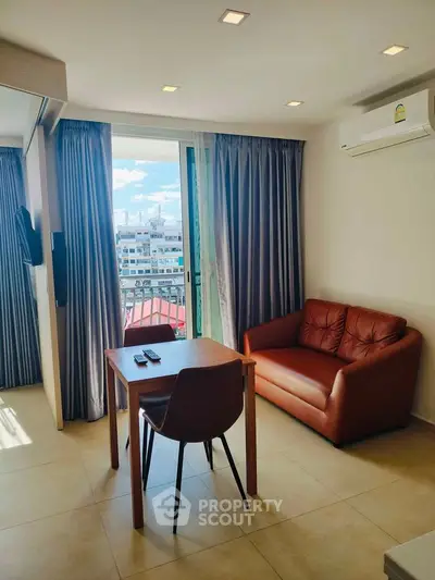 Modern living room with leather sofa and city view from window
