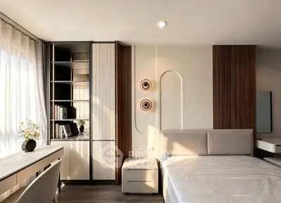 Modern bedroom with stylish decor and ample natural light, featuring a sleek study area and elegant furnishings.