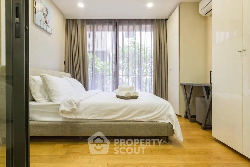 Modern bedroom with large window and stylish decor