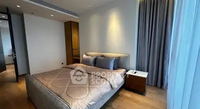 Modern bedroom with elegant decor and natural light, featuring a cozy bed and stylish curtains.