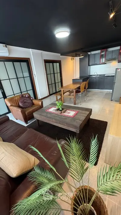 Spacious open-plan living room with modern kitchen and stylish decor