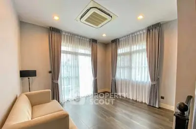 Spacious living room with elegant curtains and modern air conditioning
