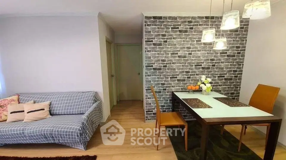 Charming living room with modern brick accent wall and cozy dining area