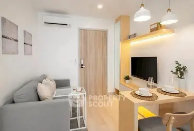 Modern living room with cozy seating and stylish dining area in a compact apartment.