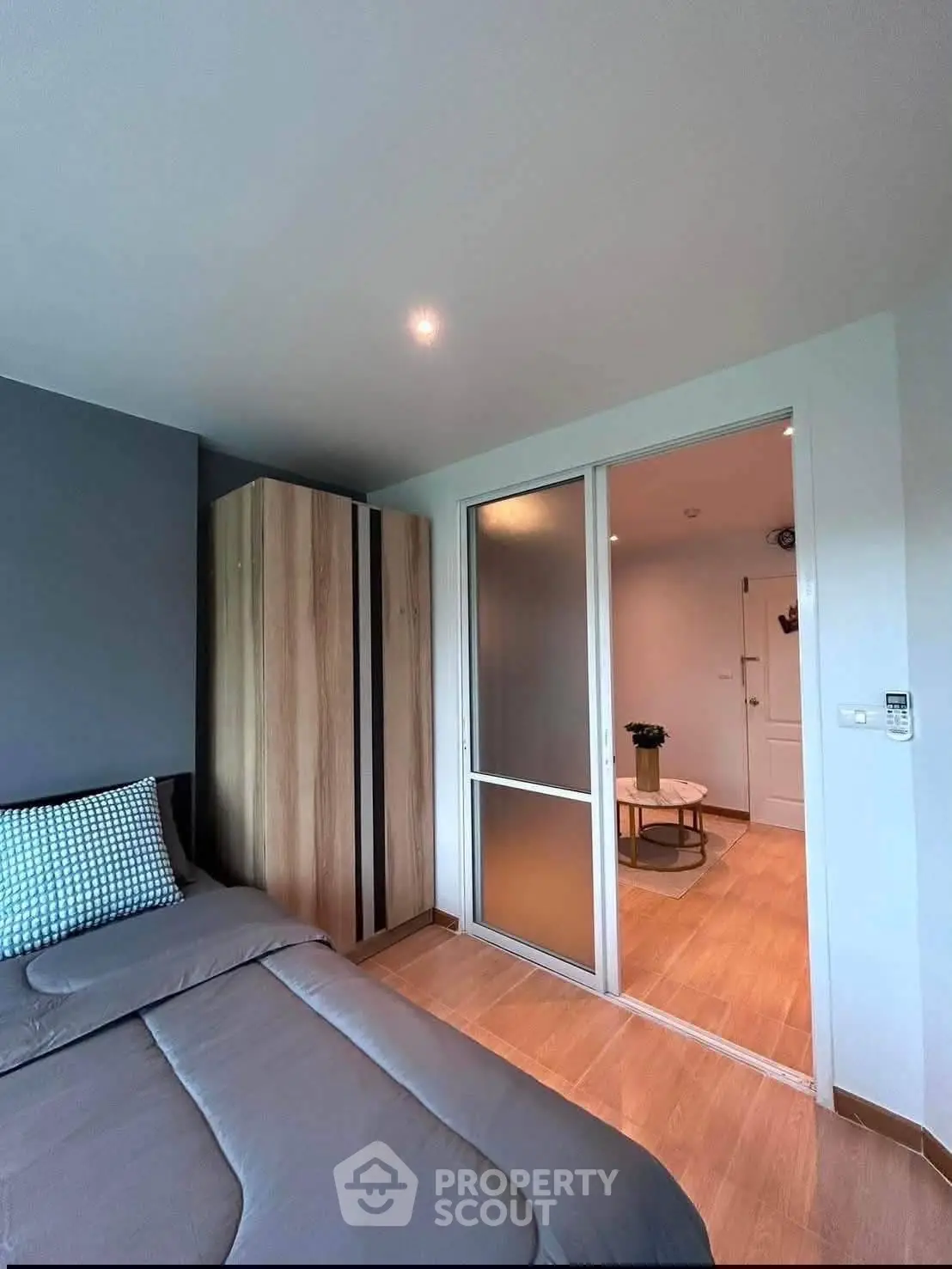 Modern bedroom with sliding door and stylish decor in a contemporary apartment.