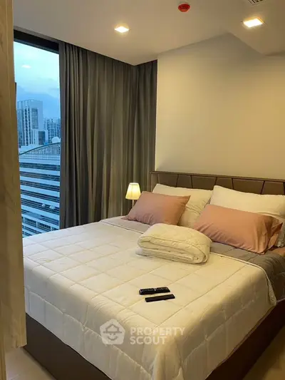 Modern bedroom with city view, featuring cozy bed and ambient lighting in a high-rise apartment.