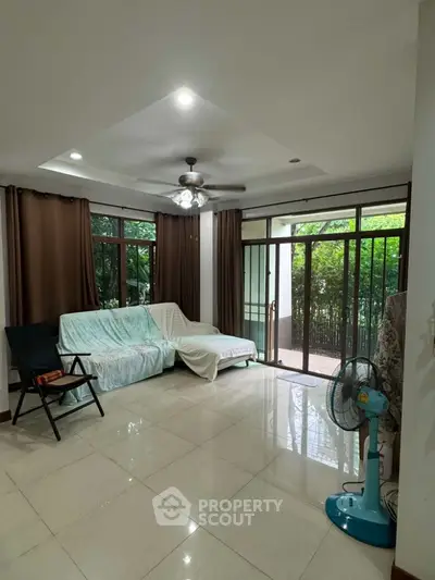 Spacious living room with large windows and garden view
