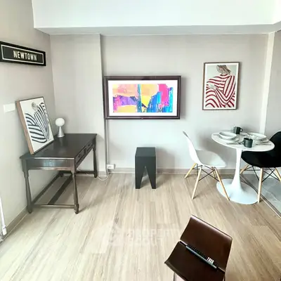 Stylish modern living room with art decor and dining area in Newtown apartment.