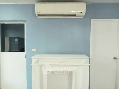 Modern interior with air conditioning and minimalist design in a serene blue room.