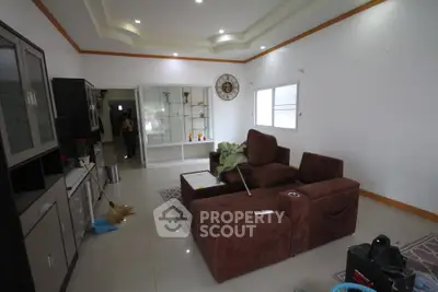 Spacious living room with modern brown furniture and elegant decor, perfect for relaxation and entertainment.