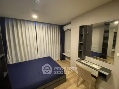 Modern bedroom with sleek design, featuring a comfortable bed, stylish desk, and ample storage space.