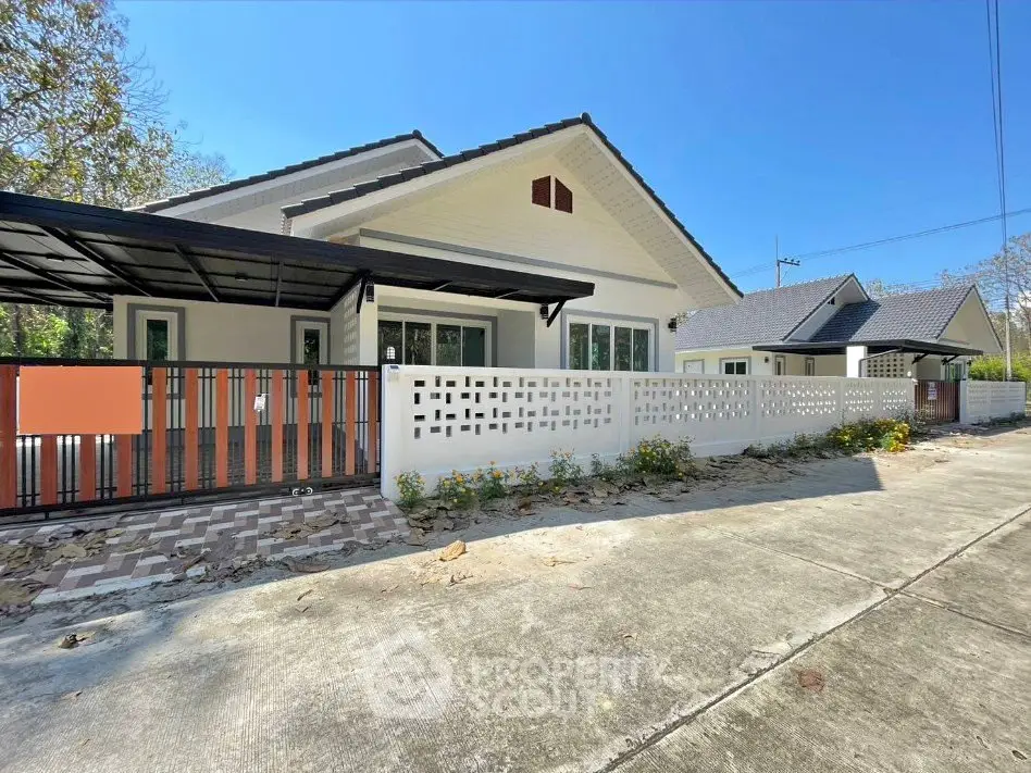 Charming single-story home with modern design and spacious driveway in a serene neighborhood.