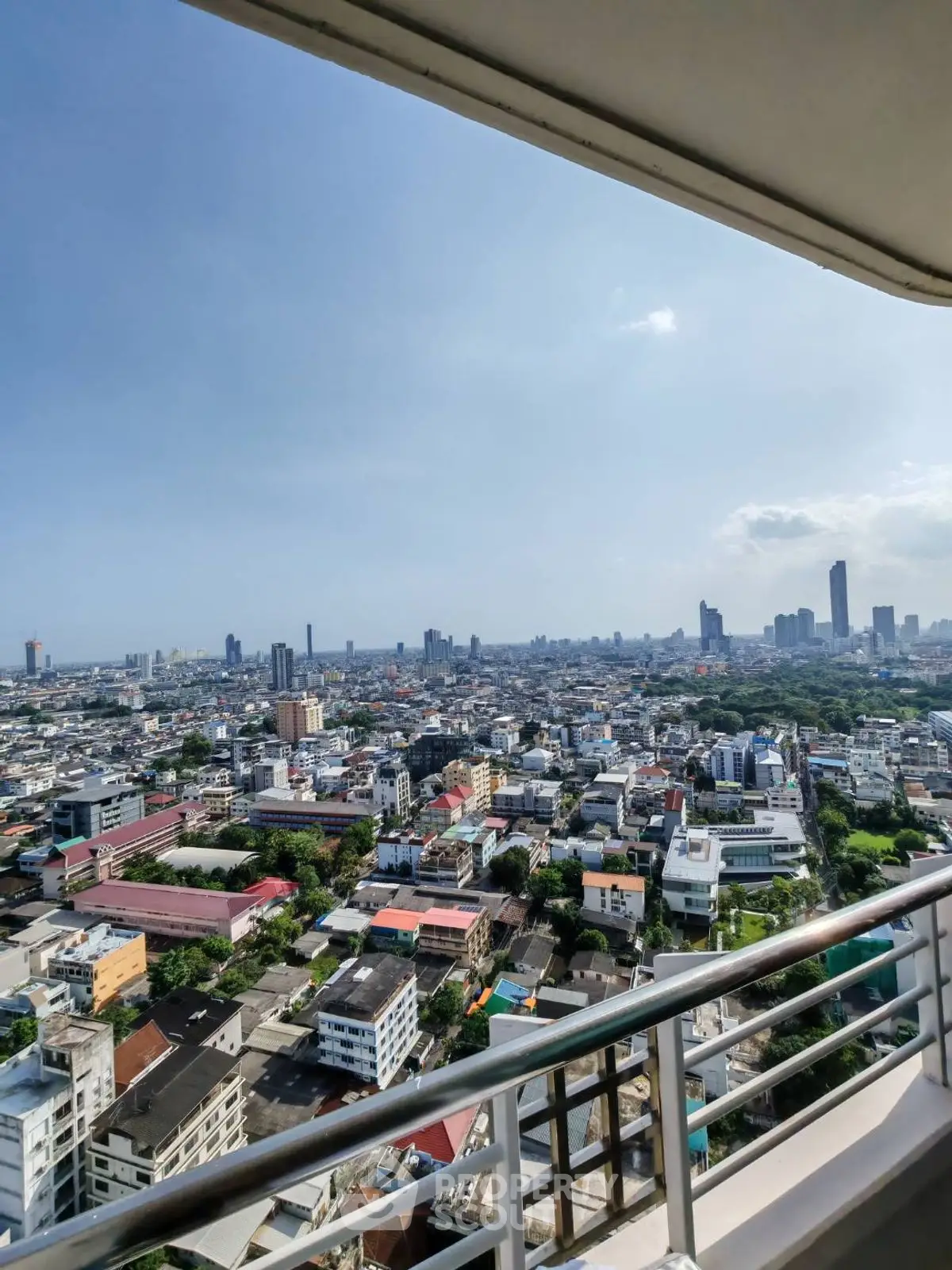 Stunning cityscape view from high-rise balcony showcasing urban skyline and vibrant city life.
