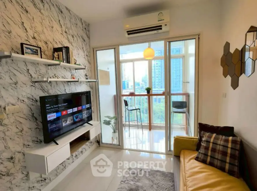 Modern living room with marble accent wall and balcony view in high-rise apartment.