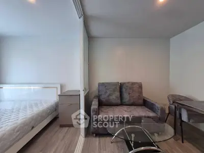 Modern studio apartment with cozy living area and stylish furniture