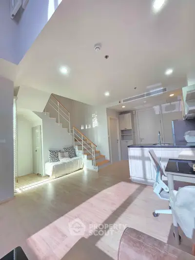 Spacious modern living room with open kitchen and natural light