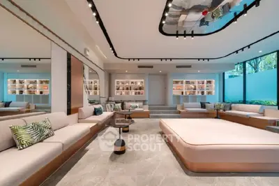 Spacious modern living room with elegant decor and large seating area, featuring stylish lighting and floor-to-ceiling windows.