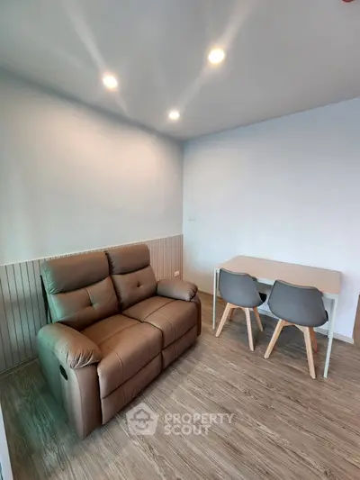 Modern minimalist living room with cozy leather sofa and stylish dining set.