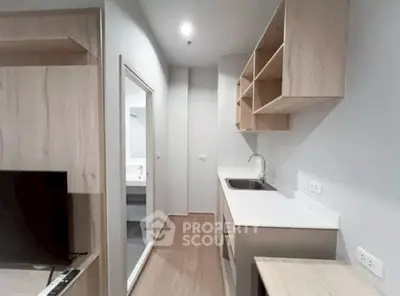 Modern kitchen with sleek cabinetry and open layout in a stylish apartment