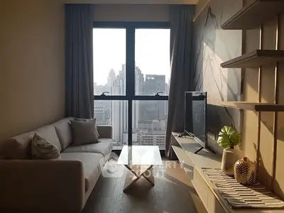 Modern living room with city view, stylish sofa, and sleek TV setup.