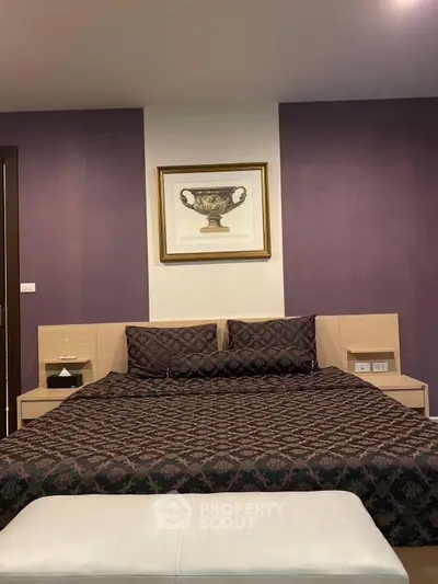 Luxurious bedroom with elegant decor and stylish bedding in modern real estate property.