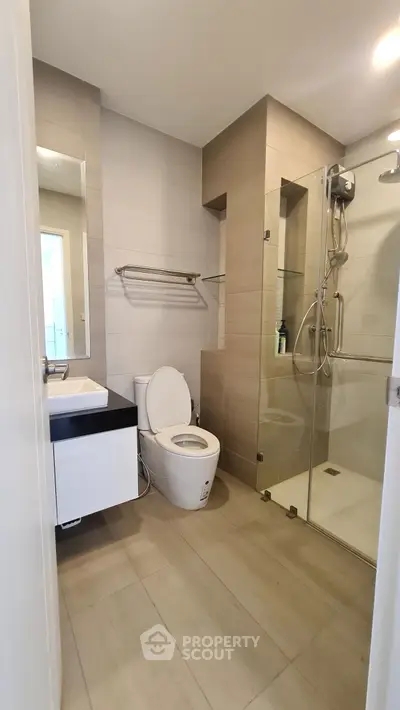 Modern bathroom with glass shower and sleek fixtures