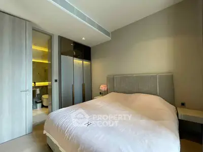 Modern bedroom with ensuite bathroom and sleek design in luxury apartment