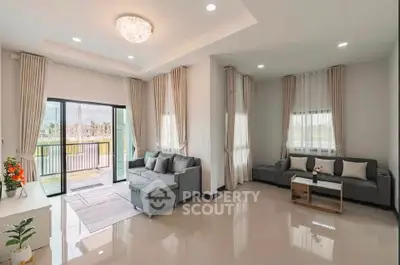 Spacious modern living room with elegant decor and large windows for natural light.